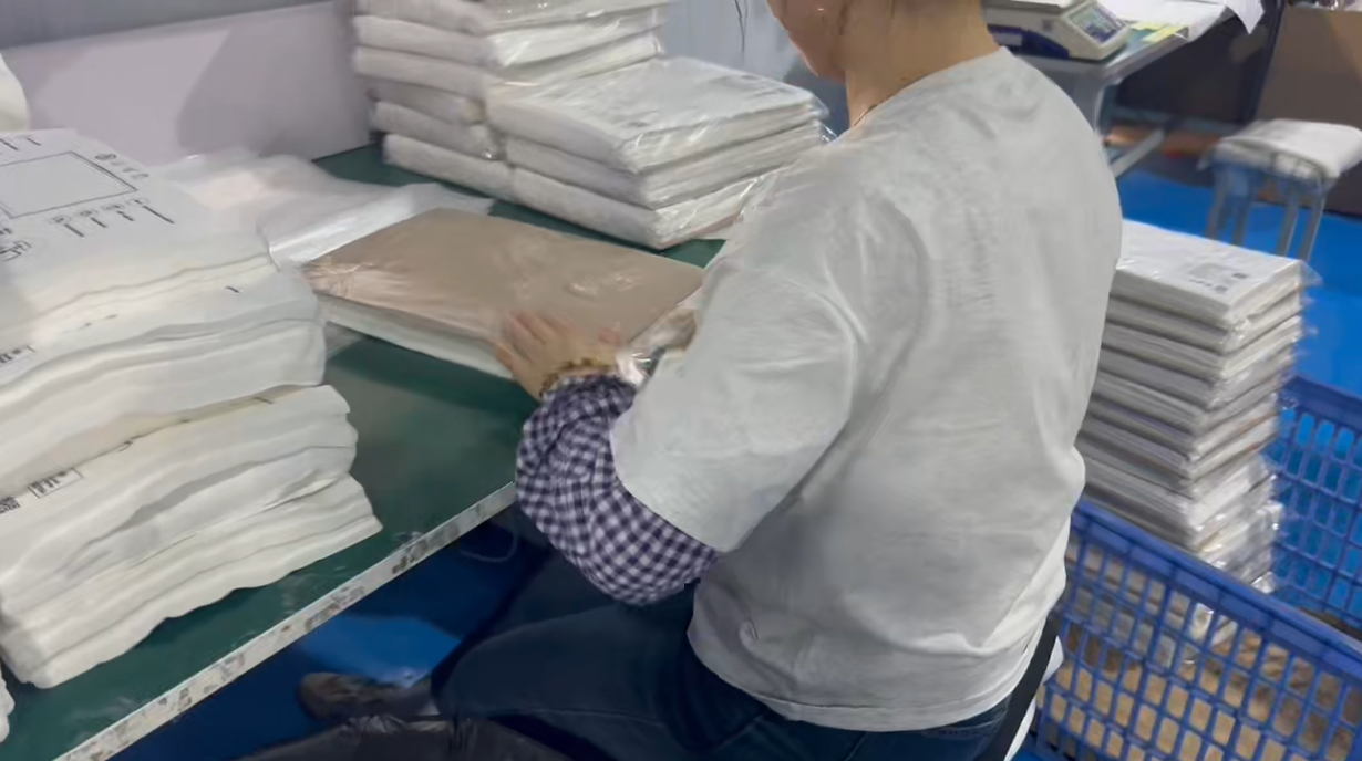 alt="Packaging and preparation of finished bamboo fiber compostable bags for shipment"